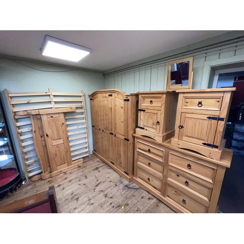 429 - Six piece pine bedroom suite comprising triple door arched top wardrobe, six drawer chest, pair pede... 