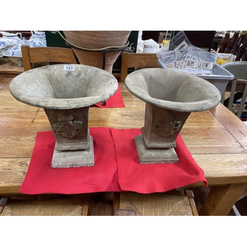 123 - Pair of small cast iron urns, 25cm high.