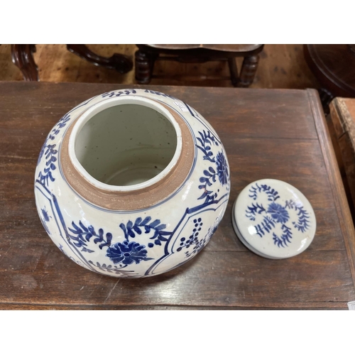 155 - Large Chinese blue and white lidded ginger jar decorated with panels and flowers, 26cm high.