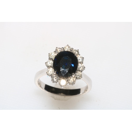 179 - Sapphire and diamond cluster ring set in 18 carat white gold, the oval sapphire 3.85 carats, diamond... 