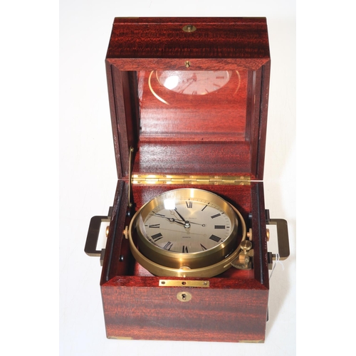 244 - Matthew Norman gimballed ships clock in mahogany case, 17cm square.