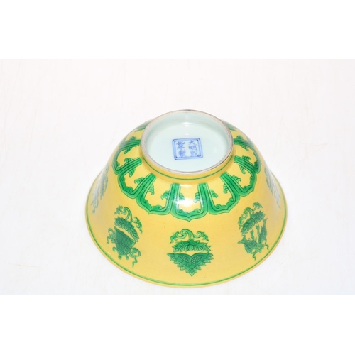 174 - Chinese yellow and green glazed patterned bowl, blue mark to base, 17.5cm diameter.