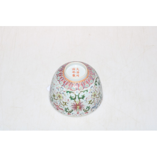 179 - Chinese famille rose tea bowl with formal decoration, six character mark, 9.5cm diameter.