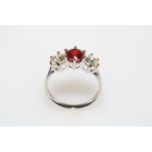 203 - Good ruby and diamond three stone 18 carat white gold ring, the over 1 carat ruby flanked by 0.85 di... 