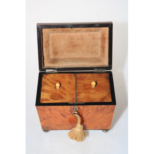 263 - 19th Century tortoiseshell twin compartment tea caddy on bun feet.