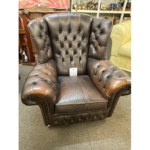 392 - Brown deep buttoned leather Chesterfield wing back armchair.