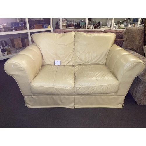 402 - Ivory leather two seater settee.