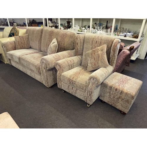 403 - Paisley patterned two seater settee, wing back chair and footstool.