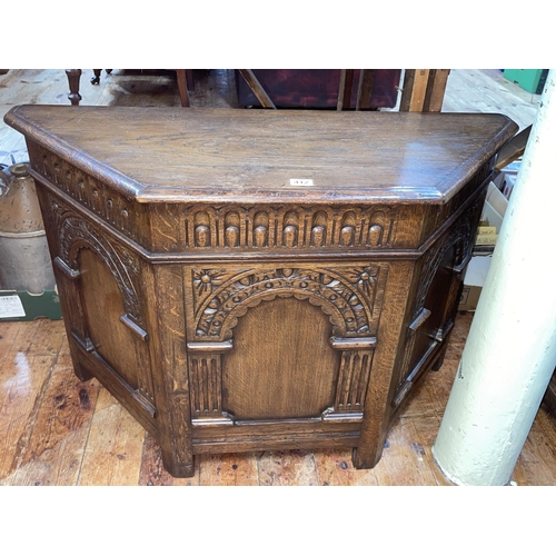 412 - Carved oak canted corner blanket box, 62cm by 93cm by 38cm.