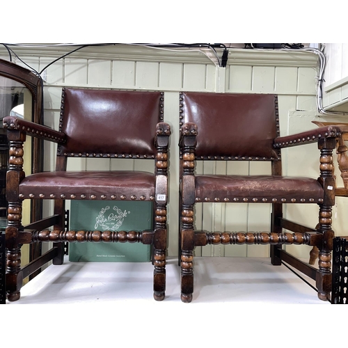 417 - Pair studded hide elbow chairs on bobbin legs.