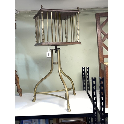 419 - Edwardian brass and mahogany revolving book stand on triform base, 80cm by 32cm by 32cm.