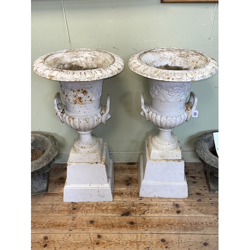 422 - Pair cast Campana style twin handled garden urns on tapering plinth bases, 85cm by 45cm diameter.