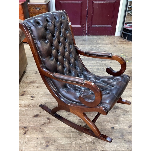 434 - Brown deep buttoned and studded leather rocking chair.