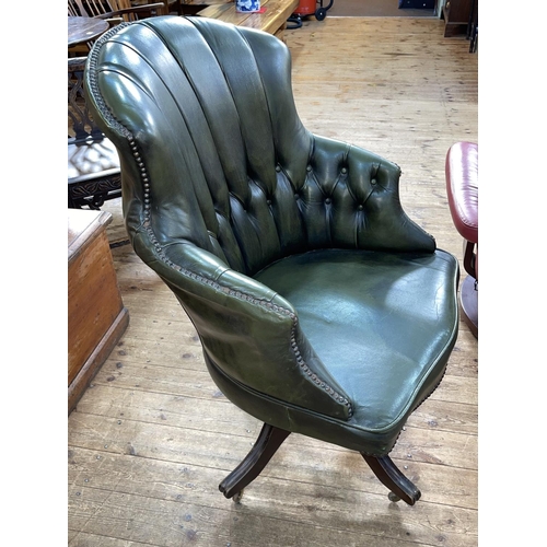 435 - Green deep buttoned and studded leather swivel office chair.