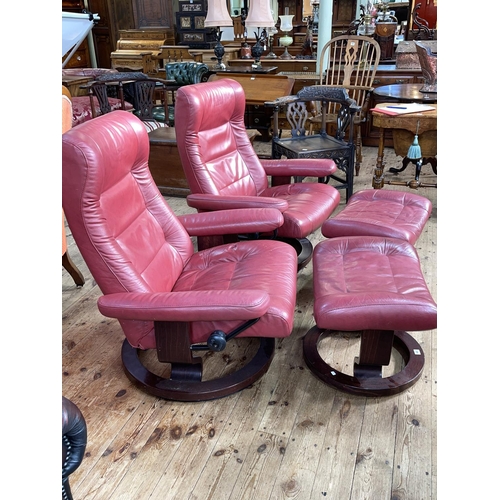 440 - Pair Ekornes Stressless adjustable armchairs and footstool in cherry leather.