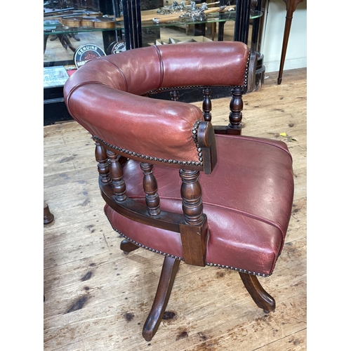 460 - Late Victorian Captains style swivel desk chair in red studded hide.