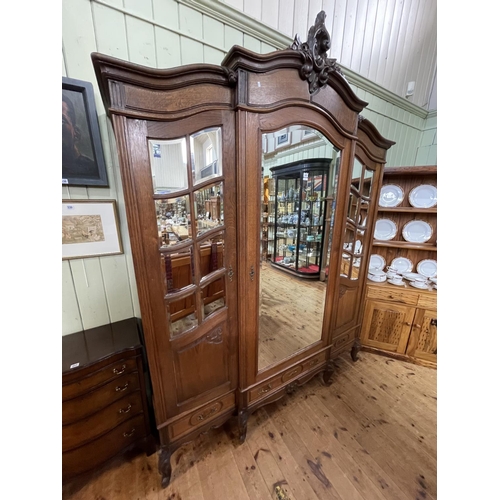 483 - French oak breakfront armoire having central mirror door flanked by two mirror panelled doors above ... 