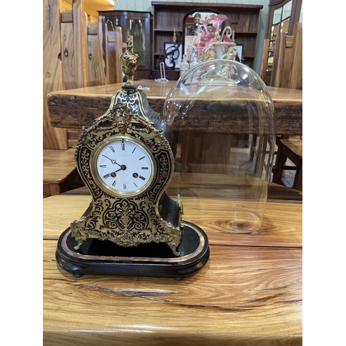 143 - French boule clock, 43cm high, under glass dome with plinth.