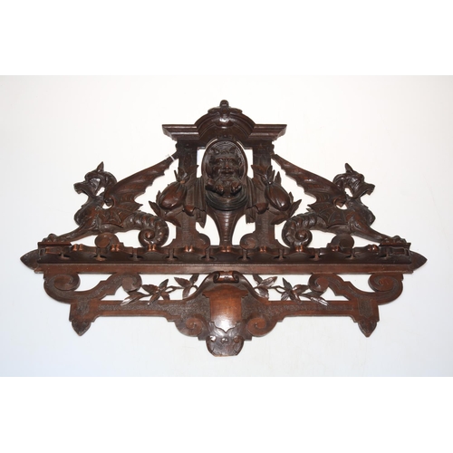 141 - Black Forest style carved wood pipe rack.