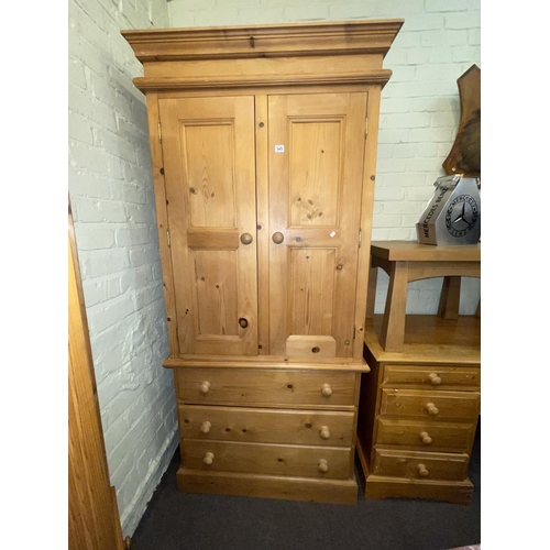 345 - Pine combination wardrobe having two doors above three drawers and similar eight drawer pedestal dre... 