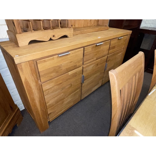 351 - Contemporary light oak eight piece dining suite comprising three door sideboard, rectangular dining ... 