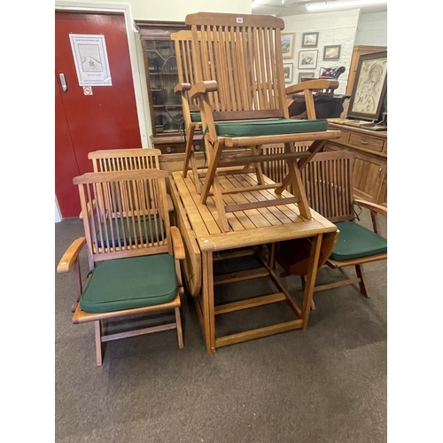 362 - Teak drop leaf garden table and six folding armchairs with seat cushions.