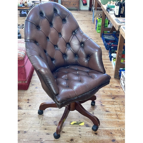 396 - Brown deep buttoned leather swivel office armchair.