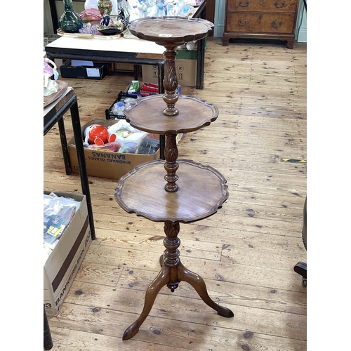 404 - Mahogany three tier shaped circular dumb waiter on tripod base, 105cm.