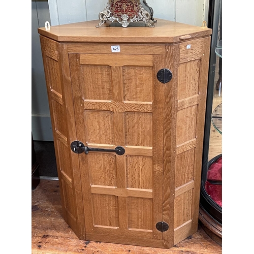 425 - Robert Thompson of Kilburn 'Mouseman' panelled oak corner wall cabinet, 97cm by 69cm by 48.5cm.