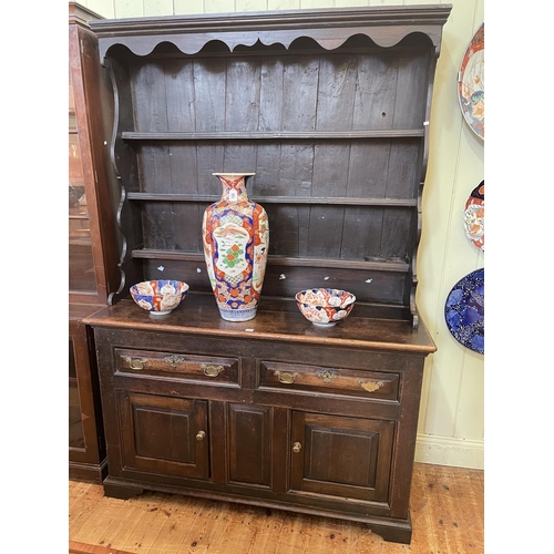 435 - Antique oak dresser, the shelf back above two drawers and two cupboard doors, 210cm by 143cm by 55cm... 