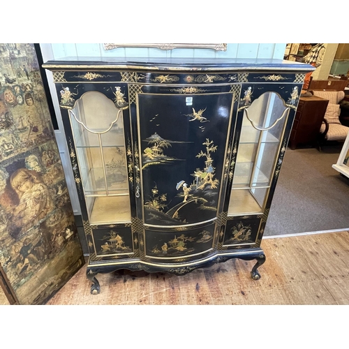 437 - Black lacquered chinoiserie cabinet having bow front central door flanked by two glazed panels on ba... 