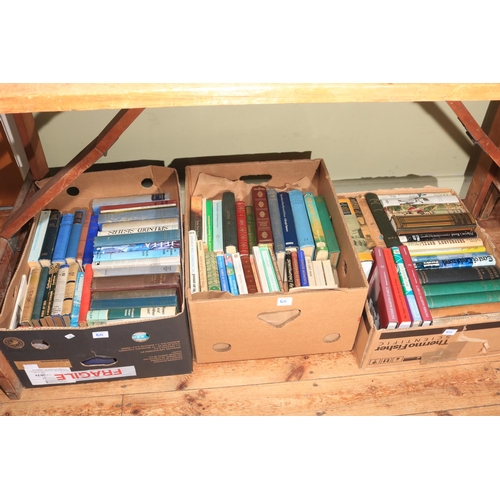 60 - Seven boxes of assorted books, novels, guides, etc.