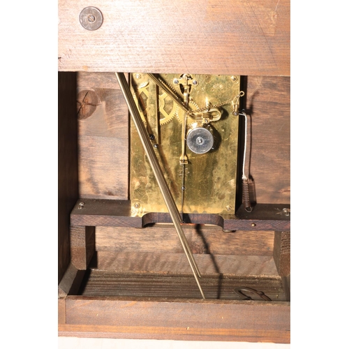 112 - A large mahogany mantel clock on bracket feet, having arched dial, 48cm high.
