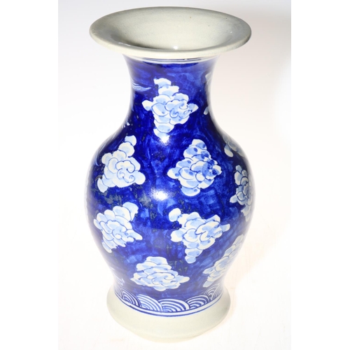136 - Large blue and white vase decorated with mythical dragon and floral design, 30cm high.