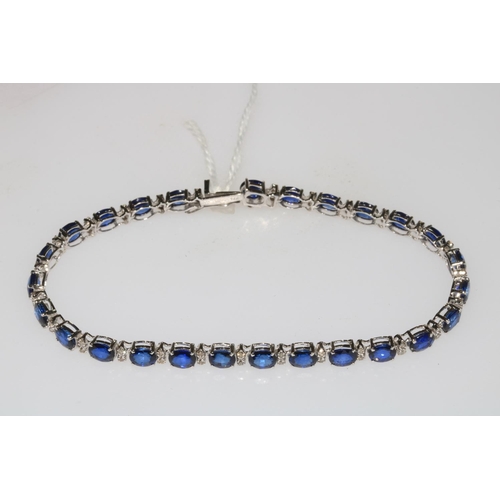 158 - Sapphire and diamond bracelet set in 18 carat white gold, containing 26 oval sapphires, each separat... 