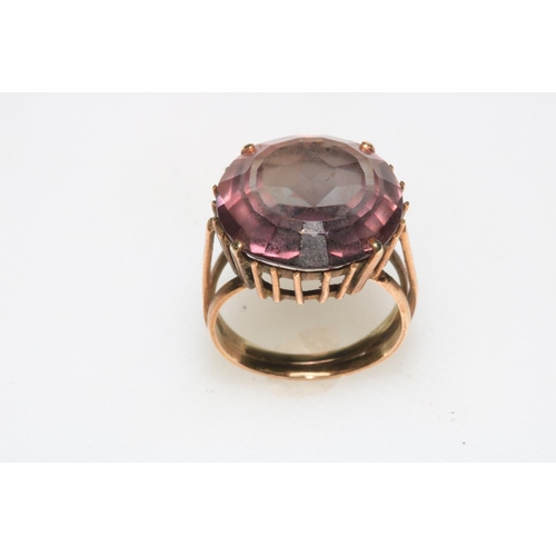 170 - Gold set circular amethyst coloured stone ring, size J/K.