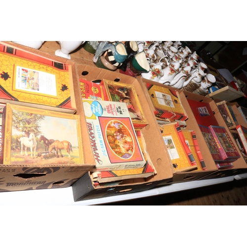 99 - Seven boxes of vintage jigsaw puzzles.