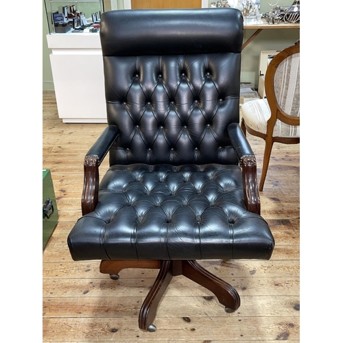 347 - Black deep buttoned leather and studded swivel office desk chair.