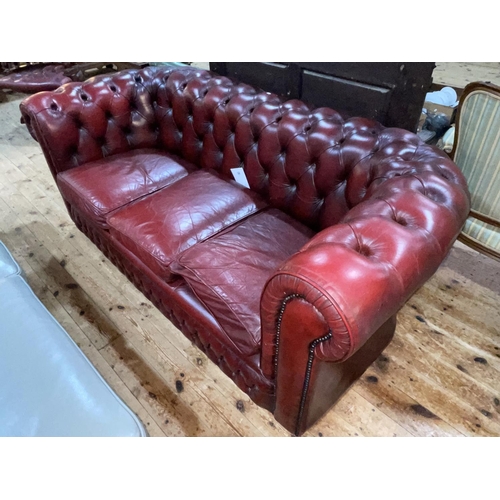 349 - Ox blood buttoned leather three seater Chesterfield settee.