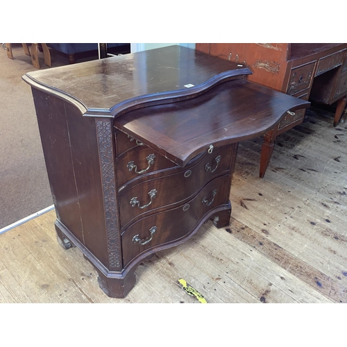 383 - Mahogany serpentine front Bachelors chest having brush slide above four long drawers on shaped brack... 