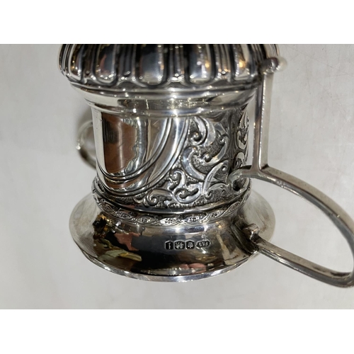 244 - Silver two handle trophy cup with embossed decoration and vacant cartouche, 14.5cm, Sheffield 1926.