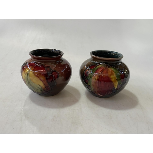 259 - Two Moorcroft Flambé leaf and berry vases, shape 55, 1950's, 6.75cm.