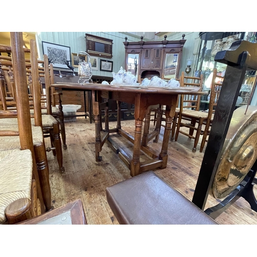 418 - Jointed oak gate leg dining table and eight country style rush seated dining chairs including pair c... 