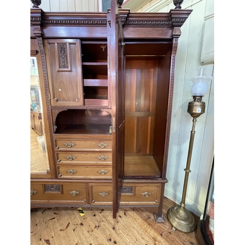 427 - Victorian carved mahogany gents combination wardrobe, 242cm by 197cm by 64cm.