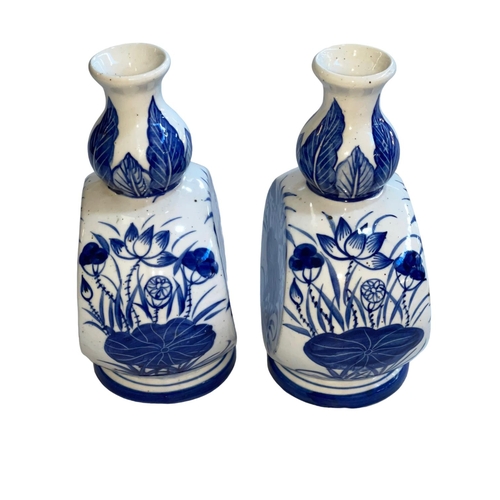 171 - Pair of 19th Century Chinese blue and white vases decorated with floral design, 22.5cm.