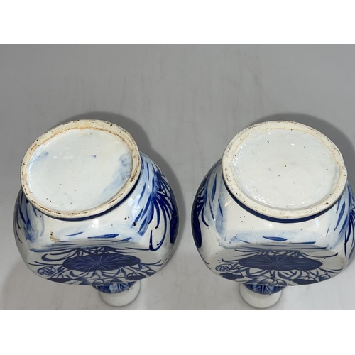 171 - Pair of 19th Century Chinese blue and white vases decorated with floral design, 22.5cm.