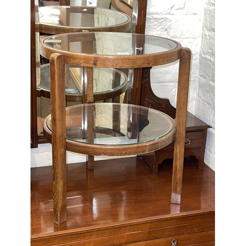 309 - Circular two tier glass inset table and collection of three various wall mirrors (4).