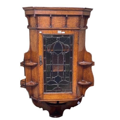 413 - Early 20th Century oak corner wall cabinet having leaded coloured glass panel door and open side she... 