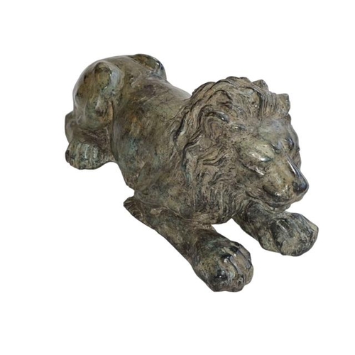 154 - Hollow bronze sculpture of a recumbent lion, 26cm long.