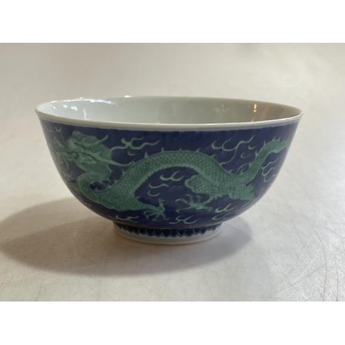 167 - Chinese bowl decorated with green painted dragon on blue ground, blue Qianlong mark to base, 15cm.